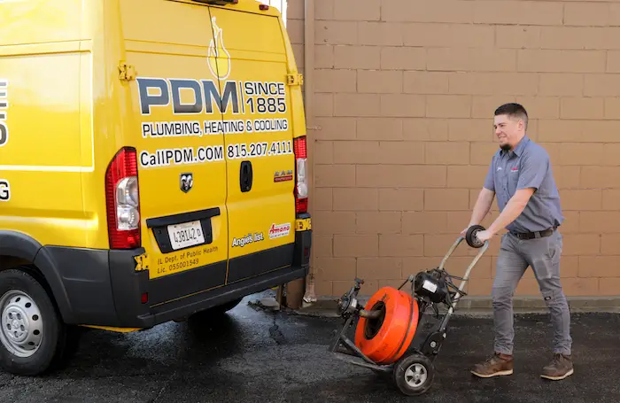 Pdm Drain Cleaning Serviceman Removing Power Drain Cleaning Machine From Truck