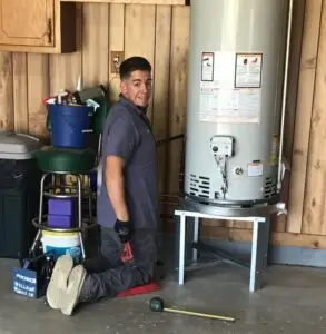 Skilled plumber during a water heater repair service.