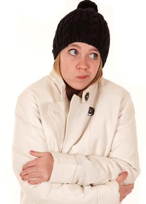 Woman cold in jacket and hat waiting for humidifier to be repaired