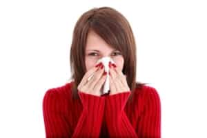 Woman wiping nose with tissue needing air cleaner image 1