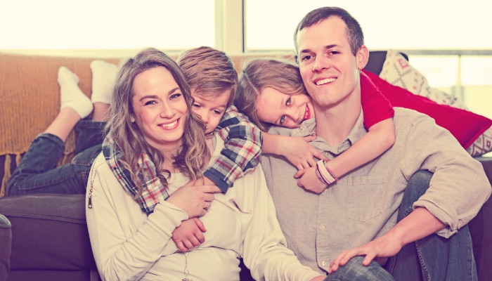 Smiling Family On Sofa Photo