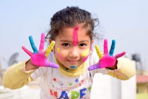 Young girl with painted hands and face