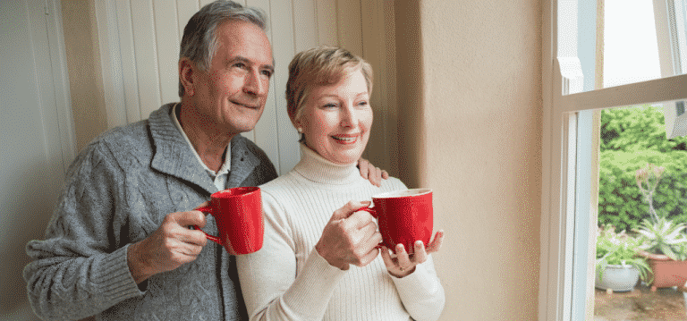 Seniors Husband and Wife Smiling Drinking Tea With New Air Cleaner Photo 1